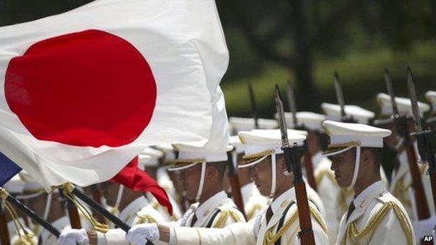 In this 29 July 2014 photo, members of a Japan Self-Defense Forces' honour guard prepare to be inspected by French Defense Minister Jean-Yves Le Drian at the Defence Ministry in Tokyo.