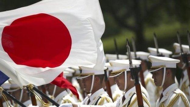 In this 29 July 2014 photo, members of a Japan Self-Defense Forces' honour guard prepare to be inspected by French Defense Minister Jean-Yves Le Drian at the Defense Ministry in Tokyo.