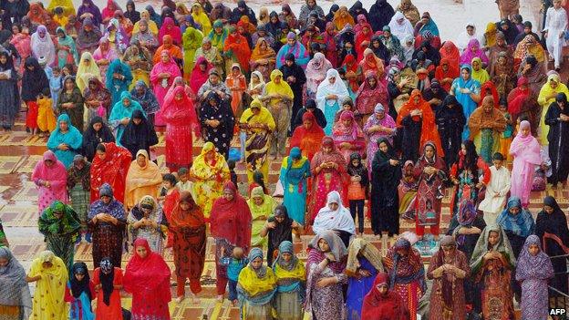 Women wearing colourful headscarves during Eid in Pakistan