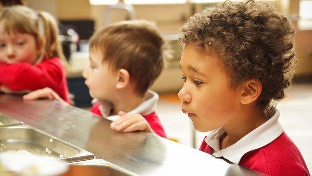 Infant children queue for lunch