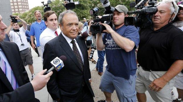 Surrounded by reporters, former Star Scientific CEO Jonnie Williams leaves federal courthouse in Richmond, Va., after testifying 31 July 2014