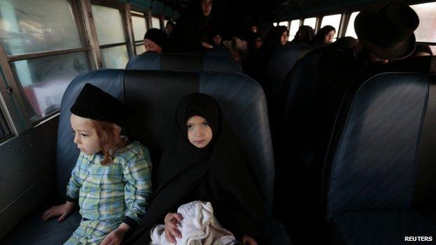Lev Tahor members prepare to leave San Juan La Laguna on a bus