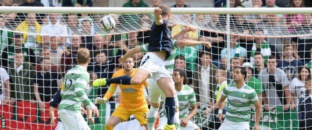 James McPake rises above the Celtic defence to give Dundee an early lead