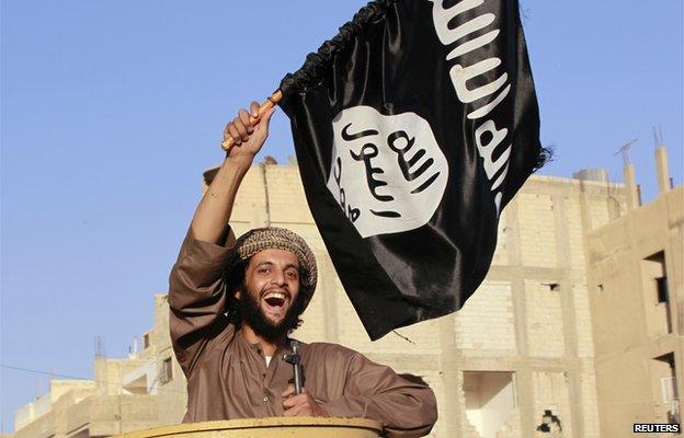 A militant islamist fighter takes part in an ISIS parade in Syria's eastern city of Raqqa June 30 2014