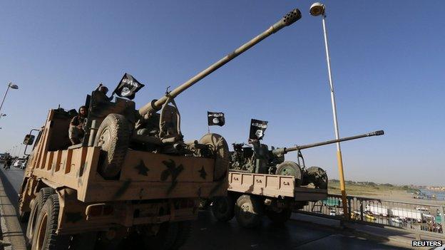 Militant Islamist fighters from IS take part in a parade in Raqqa Syria 30 June 2014