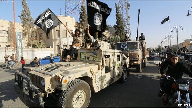 Militant Islamist fighters from IS take part in a parade in Raqqa Syria 30 June 2014