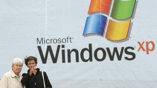 Women in front of Windows XP poster