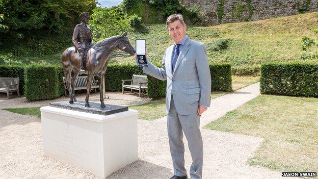 Brough Scott and statue of Warrior