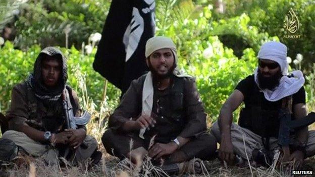 A video screengrab of three Islamic militants sitting on the ground speaking to the camera