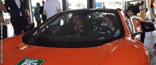 Cristiano Ronaldo gets a driving lesson from Jenson Button