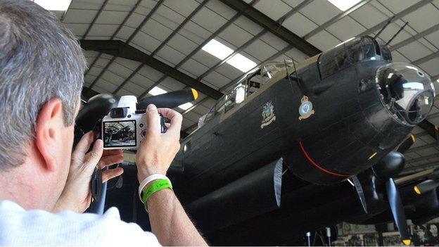 Man takes picture of Lancaster Bomber