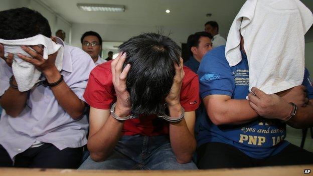 Members of a group who call themselves 'USAFE', wait for inquest proceedings at the Department of Justice in Manila, Philippines on Tuesday, 2 September 2014