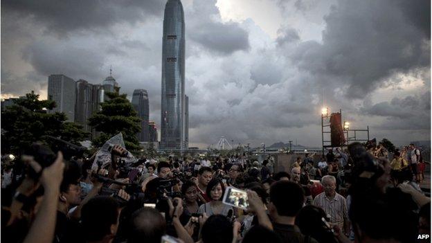 Benny Tai (R, obscured by reporters), co-founder of the Occupy Central movement, talks to the media at a rally near the Hong Kong government complex on 31 August 2014.