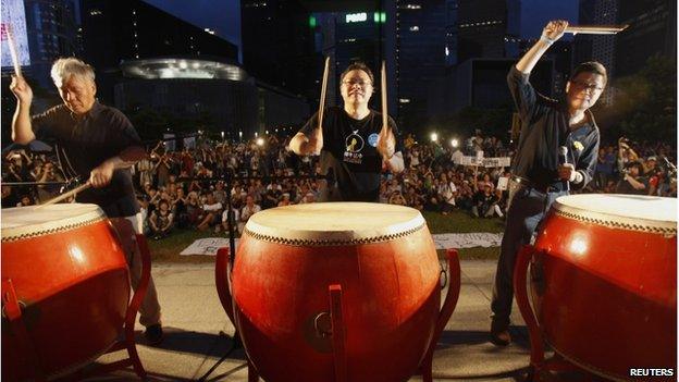 Founders of the Occupy Central civil disobedience movement, Reverend Chu Yiu-ming, academic Benny Tai and academic Chan Kin-man, hit drums during a campaign to kick off the movement in front of the financial Central district in Hong Kong 31 August 2014