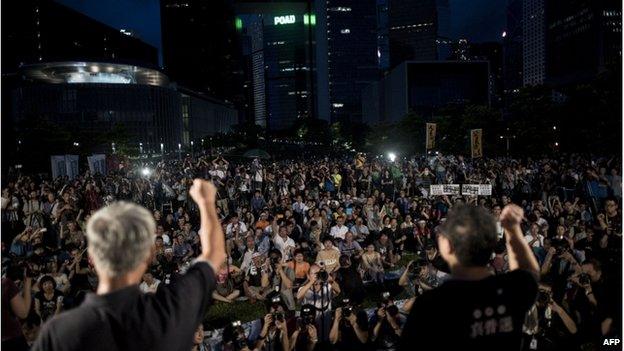 Benny Tai (right), co-founder of the Occupy Central movement, rallies with democracy activists next to the Hong Kong government complex on 31 August 2014.