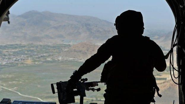 US soldier, part of the NATO-led International Security Assistance Force (ISAF), manning a machine gun onboard a Chinook helicopter over the Gardez district of Paktia province on 11 August 2014