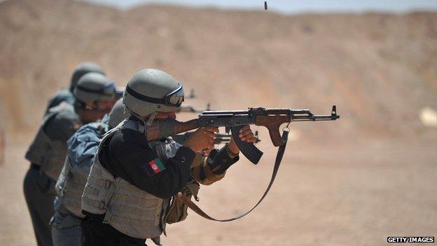 Members of the Afghanistan National Policemen (ANP) fire their AK47 rifles during shooting course taught by US Marines at Camp Leatherneck in Helmand Province on 19 June 2012.