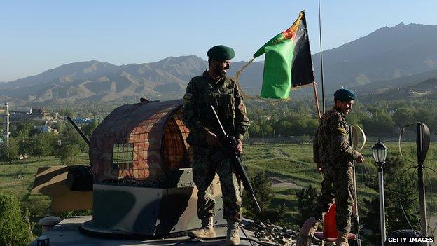 Afghan National Army (ANA) soldiers stand guard during an election campaign rally by presidential candidate Abdullah Abdullah in Paghman district of Kabul province on 9 June 2014