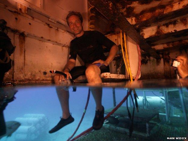 Fabien Cousteau sits in the wet porch