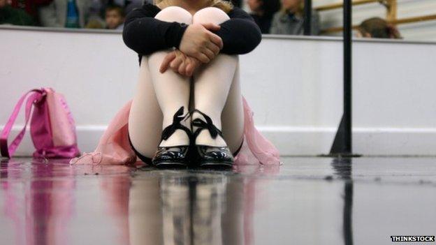 Child sitting in tap class