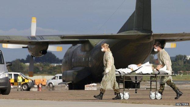 German army medical personnel transport a wounded Ukrainian soldier at Berlins Tegel airport - 2 September 2014