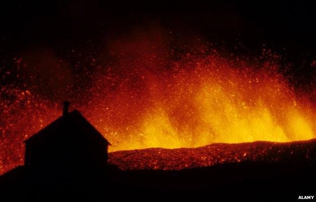 Volcanic eruption, erupting lava with town house silhouetted, Eldfell Volcano, Heimaey, Westmann Isles, Iceland, 1973