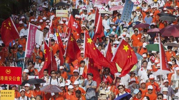 Pro-China protestors, opponents of the pro-democracy "Occupy Central" movement, march through the streets of Central District, Hong Kong, 17 August 2014