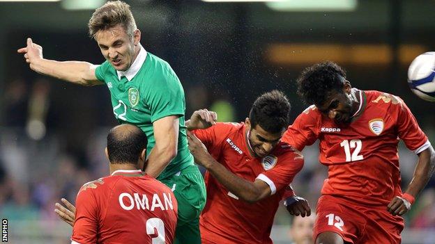 Kevin Doyle heads in the opener against Oman