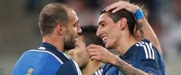 Argentina's Angel Di Maria (right) celebrates scoring against Germany