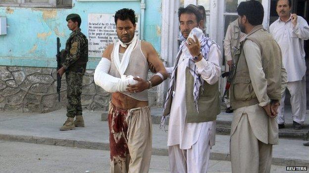 An Afghan man walks outside after receiving treatment at a hospital after a suicide bomb attack in Ghazni Province, on 4 September 2014.