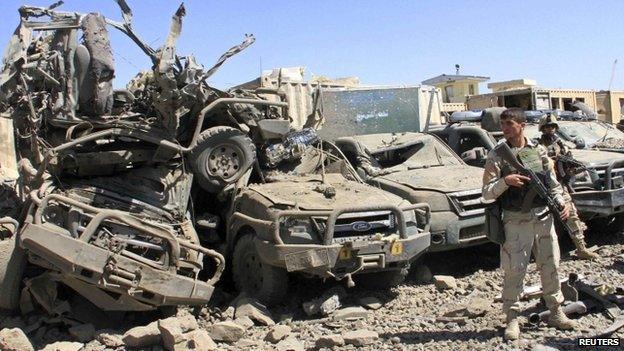 Members of the Afghan security force keep watch at the site of a suicide bomb attack in Ghazni Province 4 September 2014.