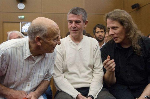 Greenpeace activists Peter Wentt (L), Jean-Michel Vougere (C) and Eddy Varin (R) talk in a courthouse in Colmar, eastern France, 4 September