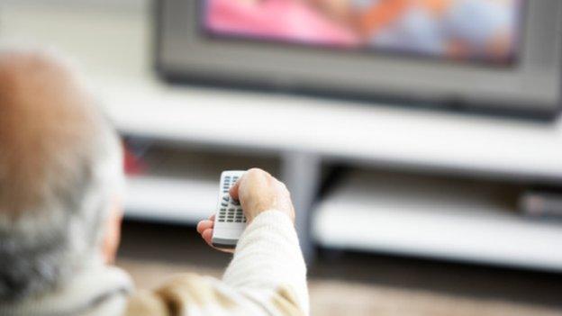 Elderly man watching TV