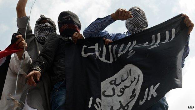 Kashmiri demonstrators holding an Islamic State flag in Srinagar - 18 July 2014