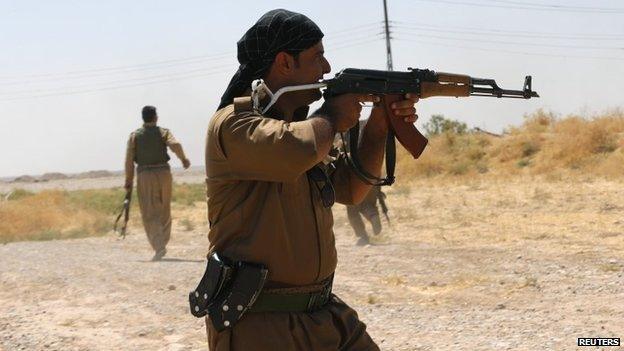 A Kurdish fighter shoots towards Islamic State gunmen during clashes in northern Iraq - 4 September 2014