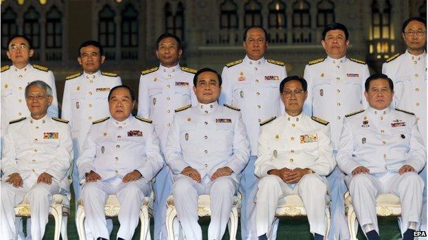 Thai military junta chief and newly appointed Prime Minister General Prayuth Chan-ocha (centre, seated) and unidentified cabinet members pose for a group photo after a swearing-in ceremony at the Government House in Bangkok, Thailand, 4 September 2014.