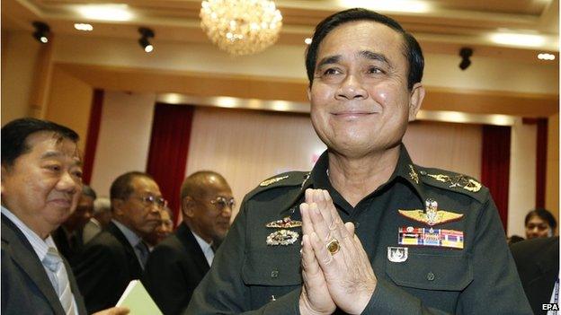 Thai military junta head and newly Prime Minister General Prayuth Chan-ocha (right) greets in the traditional Thai way as he leaves after a meeting of the instruction on the procedures of members of the national reform council at the Army Club in Bangkok, Thailand, 4 September 2014.