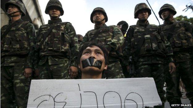 A Thai protester shows his disapproval with the military during an anti-coup protest despite the martial law 23 May 2014 in Bangkok, Thailand.