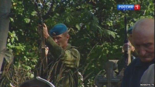 Russian solider performing a salute at the funeral of Anatoly Travkin