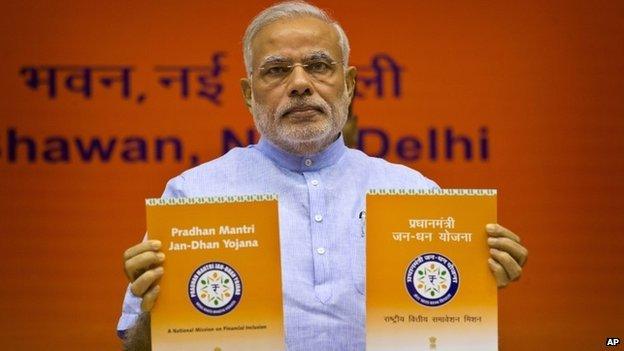 PM Narendra Modi unveils the logo of a campaign aimed at opening millions of accounts for poor Indians in Delhi on Thursday, Aug. 28, 2014