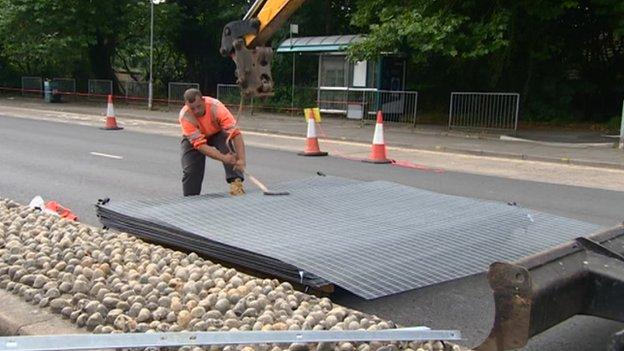 Workers removing security barriers in Cardiff