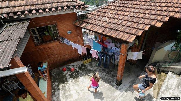 Members of the Das Neves family gather in their home in the Prazeres favela on 19 October 2013 in Rio de Janeiro, Brazil. The family participates in Brazil's 'Bolsa Familia'