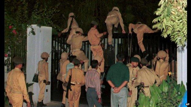 Pakistan Army Soldiers climb gates of Pakistan TV headquarters during coup to remove democratically elected government - October 12 1999