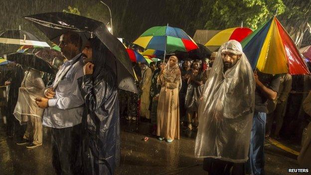 Anti-government protesters listen to a speech by their leader Tahir ul-QadrI