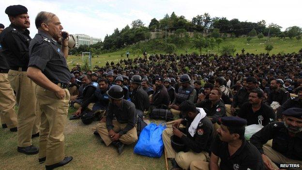 Police officer speaks to a gathering of policemen brought to the capital Islamabad as reinforcements during Revolution March in Islamabad