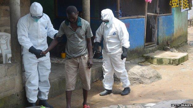 Nurses helping man with Ebola