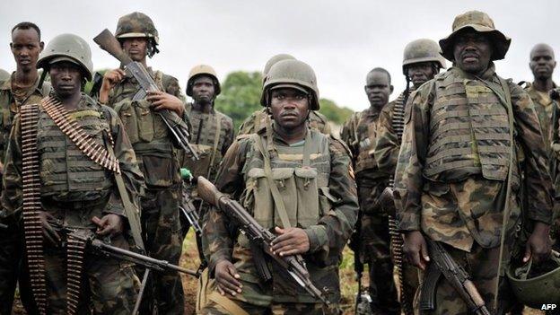 A handout picture taken and released on 31 August 2014 by the African Union-United Nations Information Support Team shows Ugandan soldiers, as part of the African Union Mission in Somalia, preparing to advance on a town in the Lower Shabelle region of Somalia