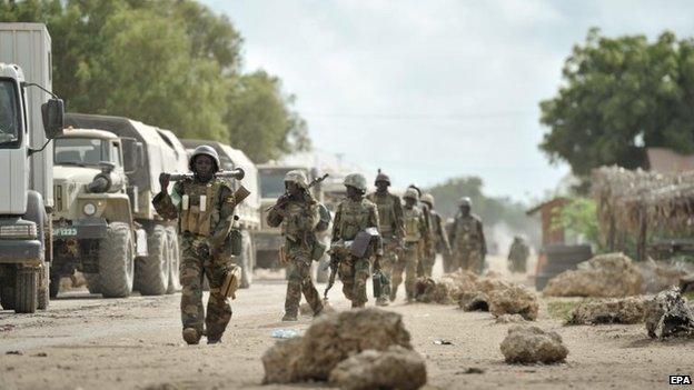 A handout photograph made available by the African Union Mission in Somalia showing Ugandan troops, as part of the African Union force, marching through the town of Golweyn after having liberated it from al-Shabab in Somalia's Lower Shabelle region on 30 August 2014