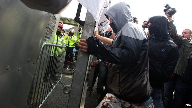 Protesters are blocked by a security barrier at the Celtic Manor Resort in Newport