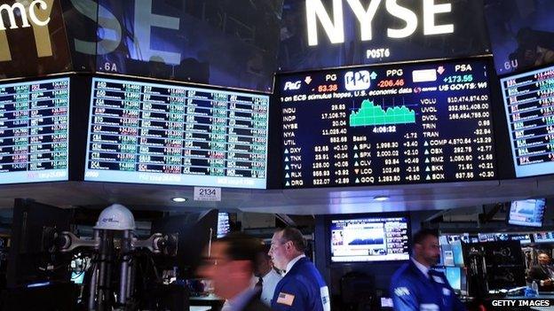 Traders work on the floor of the New York Stock Exchange (NYSE) in New York City, 26 August 2014